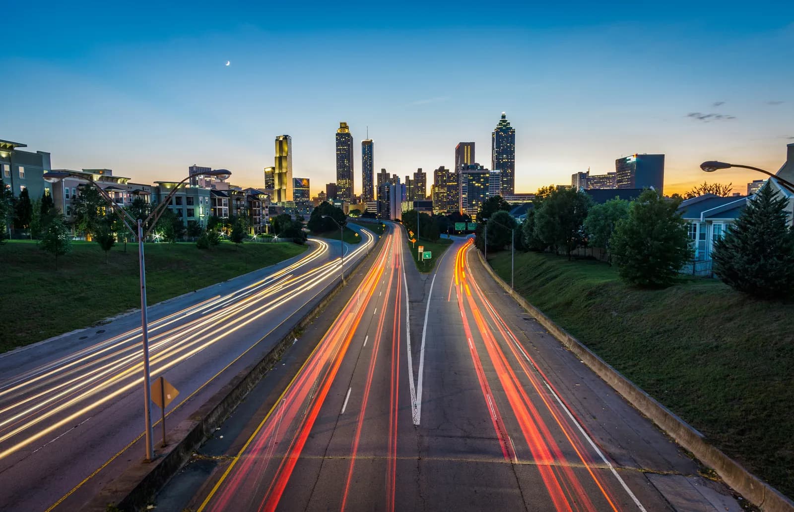 City highway at dusk with skyline